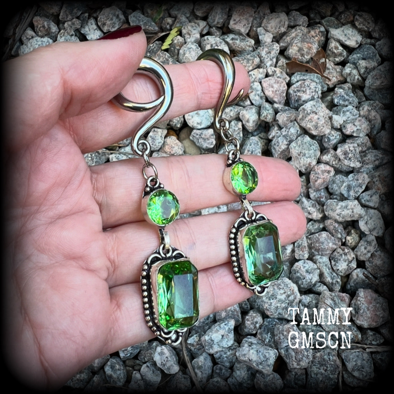 This pair of beautifully dangly earrings features gorgeous green peridot gemstones in a boho antique silver setting, weighing approx 14 grams a piece and measuring just on 8.5cms from tip to tip.

This pair have been made on 2 gauge (6mm) surgical steel full curl hooks, to be worn in stretched lobes.