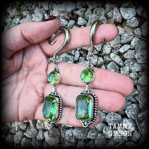 This pair of beautifully dangly earrings features gorgeous green peridot gemstones in a boho antique silver setting, weighing approx 14 grams a piece and measuring just on 8.5cms from tip to tip.

This pair have been made on 2 gauge (6mm) surgical steel full curl hooks, to be worn in stretched lobes.