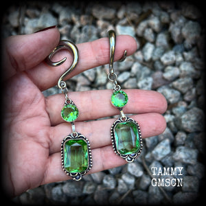 This pair of beautifully dangly earrings features gorgeous green peridot gemstones in a boho antique silver setting, weighing approx 14 grams a piece and measuring just on 8.5cms from tip to tip.

This pair have been made on 2 gauge (6mm) surgical steel full curl hooks, to be worn in stretched lobes.