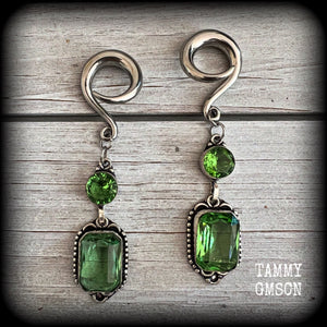 This pair of beautifully dangly earrings features gorgeous green peridot gemstones in a boho antique silver setting, weighing approx 14 grams a piece and measuring just on 8.5cms from tip to tip.

This pair have been made on 2 gauge (6mm) surgical steel full curl hooks, to be worn in stretched lobes.