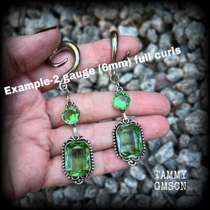 This pair of beautifully dangly earrings features gorgeous green peridot gemstones in a boho antique silver setting, weighing approx 14 grams a piece and measuring just on 8.5cms from tip to tip.

This pair have been made on 2 gauge (6mm) surgical steel full curl hooks, to be worn in stretched lobes.