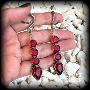 These stunning dangly gauged earrings feature gorgeous deep red faceted garnet gemstones in an ornate antique silver setting, measuring just over 8cms from tip to tip, and weigh approx 9 grams each.

This pair have been made with 6 gauge (4mm) surgical steel full curl hooks, to be worn in stretched lobes.