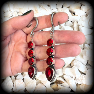 These stunning dangly gauged earrings feature gorgeous deep red faceted garnet gemstones in an ornate antique silver setting, measuring just over 8cms from tip to tip, and weigh approx 9 grams each.

This pair have been made with 6 gauge (4mm) surgical steel full curl hooks, to be worn in stretched lobes.
