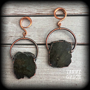 This pair of gorgeous earrings features large shimmering labradorite slices with rustic ornate copper plate detail, weighing approx 22 grams a piece, not too heavy, and measuring just on 9cms from tip to tip.

These earrings have been made on 6 gauge (4mm) surgical steel full curl hooks, to be worn in stretched lobes.