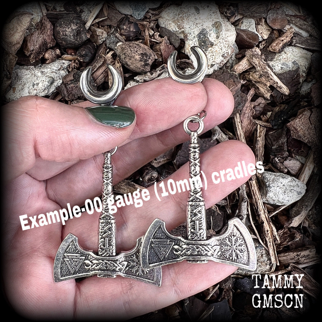 These viking axe earrings feature many Norse symbols such as runes, the viking compass and the triple triangle.
Measuring just on 8cms from tip to tip, weigh 21 grams each.
This pair has been made on 00 gauge (10mm) surgical steel cradles