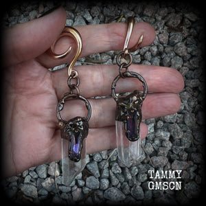 These clear quartz and amethyst gauged earrings are simply gorgeous!!
Featuring gorgeous amethyst stones sitting on front of chunky quartz pillars in an antique copper setting, these gauged earrings measure just on 9.5cms from tip to tip, and weigh approx 25 grams each.
This pair has been made on 6 gauge (4mm) surgical steel full curl hooks, suitable to be worn in stretched lobes.