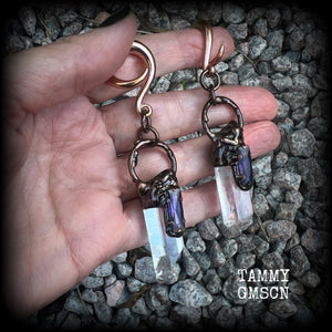 These clear quartz and amethyst gauged earrings are simply gorgeous!!
Featuring gorgeous amethyst stones sitting on front of chunky quartz pillars in an antique copper setting, these gauged earrings measure just on 9.5cms from tip to tip, and weigh approx 25 grams each.
This pair has been made on 6 gauge (4mm) surgical steel full curl hooks, suitable to be worn in stretched lobes.