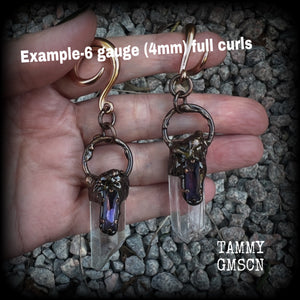 These clear quartz and amethyst gauged earrings are simply gorgeous!!
Featuring gorgeous amethyst stones sitting on front of chunky quartz pillars in an antique copper setting, these gauged earrings measure just on 9.5cms from tip to tip, and weigh approx 25 grams each.
This pair has been made on 6 gauge (4mm) surgical steel full curl hooks, suitable to be worn in stretched lobes.