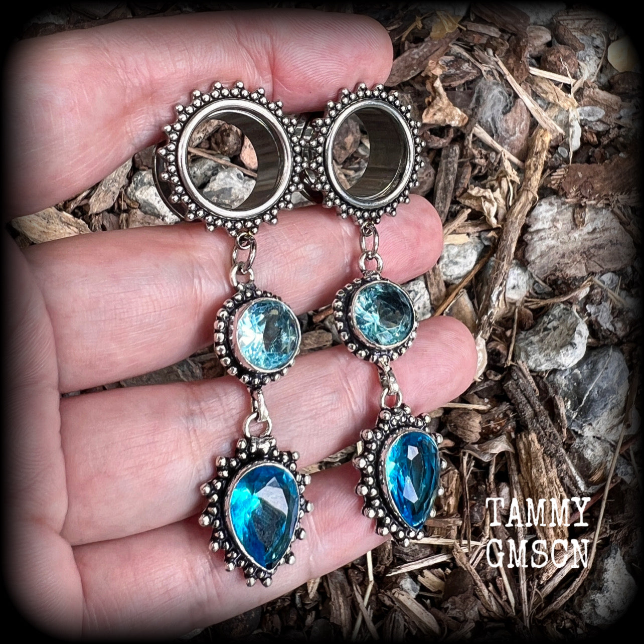 These gorgeous boho tunnel earrings have been made with beautiful ocean blue gemstones in an antique silver setting, are light weight-weighing approx 12 grams each and measure just on 7.5 cms from tip to tip.
These tunnel dangles have been made with 5/8” gauge (16mm) ornate stainless steel screw fit tunnels.