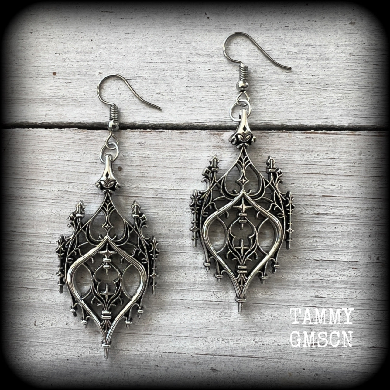 These gorgeous gothic earrings feature a beautiful antique silver ornate gothic cathedral architectural arch, measuring just on 7cms from tip to tip, and weighing approx 7 grams each.

This pair has been made with stainless steel hooks, for pierced ears.