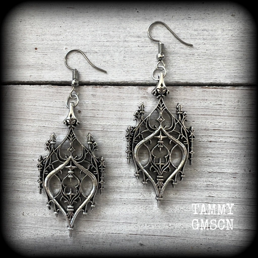 These gorgeous gothic earrings feature a beautiful antique silver ornate gothic cathedral architectural arch, measuring just on 7cms from tip to tip, and weighing approx 7 grams each.

This pair has been made with stainless steel hooks, for pierced ears.