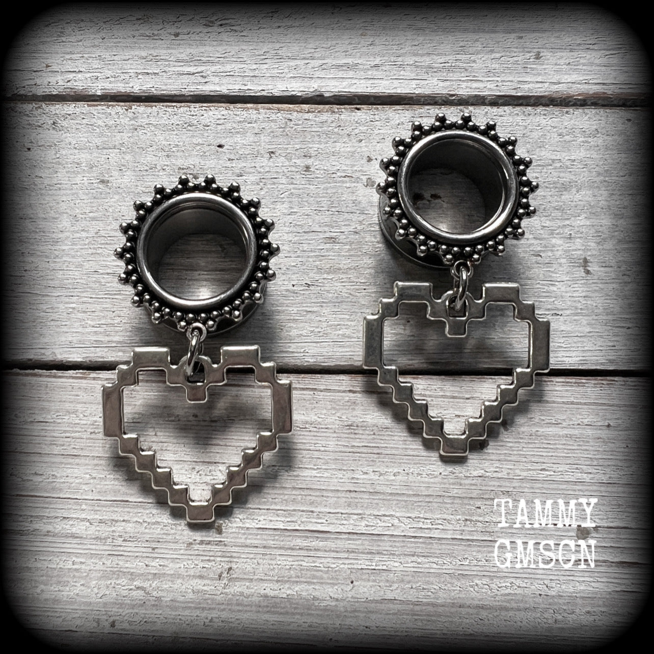 Featuring super retro antique silver pixel hearts, these tunnel earrings measure 4.5cm from tip to tip, and weigh approx 8 grams each.

This pair has been made on 9/16" (14mm) ornate surgical steel tunnels, suitable for stretched lobes.