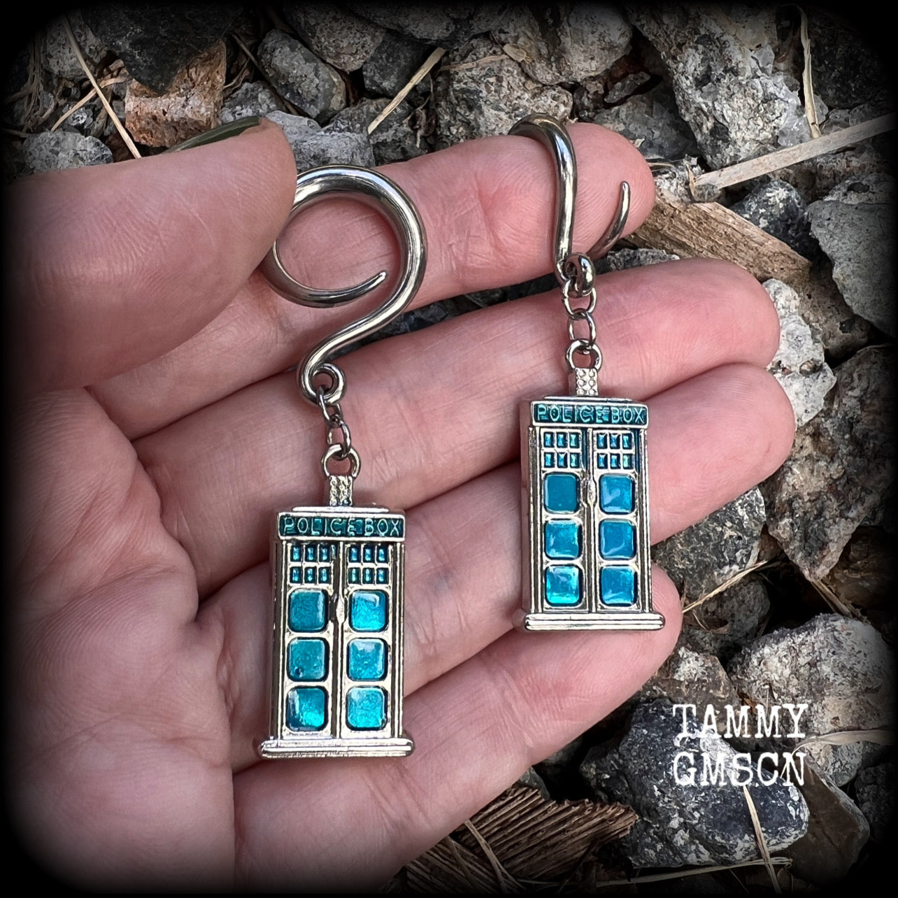 These super rad Dr Who Tardis earrings feature classic antique silver and blue enamel charms, measuring 6 cms from tip to tip, weighing in at only 8 grams each.


This pair has been made on 6 gauge (4mm) surgical steel full curl hooks, suitable for stretched lobes.