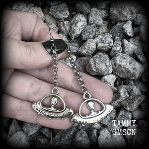 These awesome dangly antique silver earrings feature classic ‘I WANT TO BELIEVE’ alien UFO charms dangling from stainless steel chain, measuring just over 7cms from tip to tip (nice and dangly), and weighing only 3 grams each (nice and light weight).

This pair have been made on stainless steel french hooks, suitable for pierced ears.