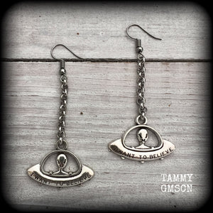 These awesome dangly antique silver earrings feature classic ‘I WANT TO BELIEVE’ alien UFO charms dangling from stainless steel chain, measuring just over 7cms from tip to tip (nice and dangly), and weighing only 3 grams each (nice and light weight).

This pair have been made on stainless steel french hooks, suitable for pierced ears.
