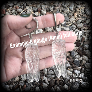These gauged earrings feature a gorgeous clear quartz cicada pendant, nice and dangly, measuring just over 9cms from tip to tip, and weighing approx 30 grams each.
This pair has been made on 6 gauge (4mm) surgical steel full curl hooks, to be worn in stretched lobes.