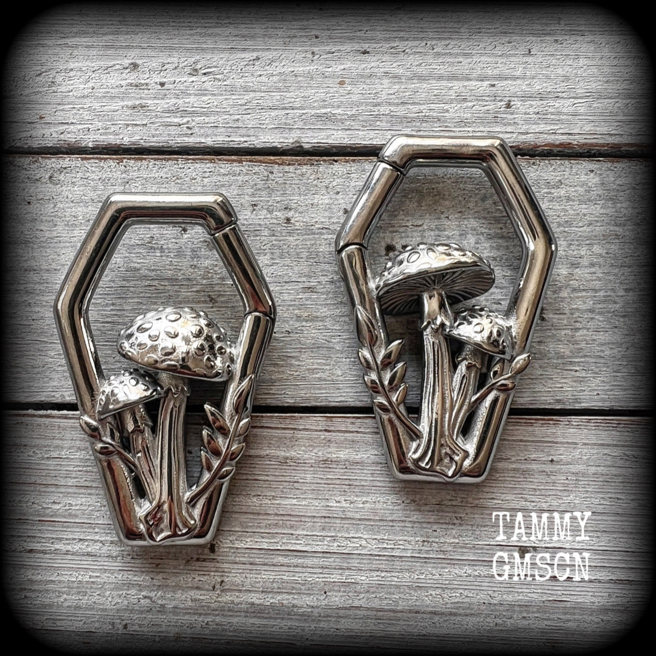 Featuring gorgeous surgical steel mushrooms enclosed in a coffin shaped frame, these earrings measure 5cms from tip to tip, and weigh approx 29 grams each.
