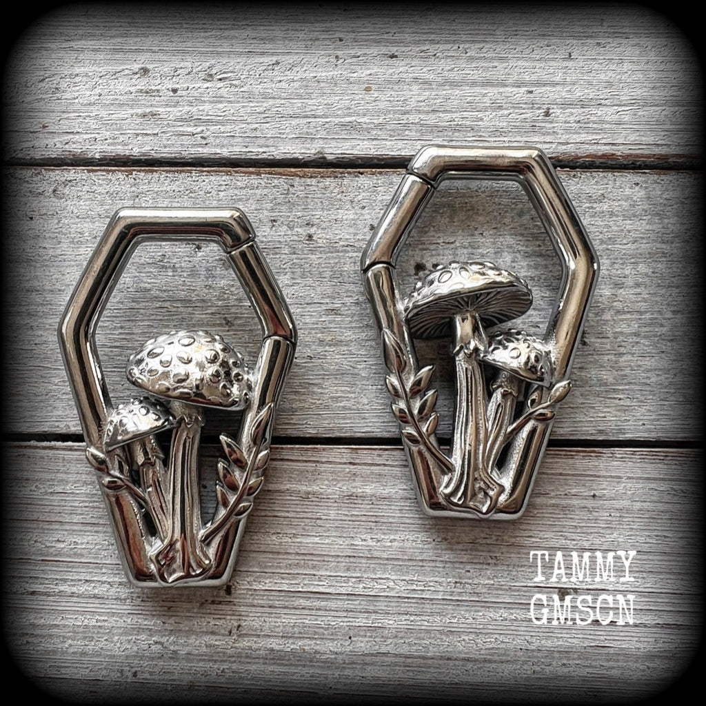 Featuring gorgeous surgical steel mushrooms enclosed in a coffin shaped frame, these earrings measure 5cms from tip to tip, and weigh approx 29 grams each.
