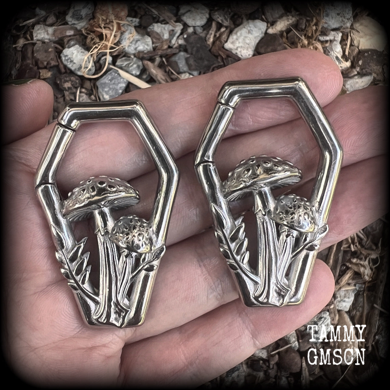 Featuring gorgeous surgical steel mushrooms enclosed in a coffin shaped frame, these earrings measure 5cms from tip to tip, and weigh approx 29 grams each.