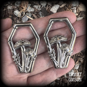 Featuring gorgeous surgical steel mushrooms enclosed in a coffin shaped frame, these earrings measure 5cms from tip to tip, and weigh approx 29 grams each.