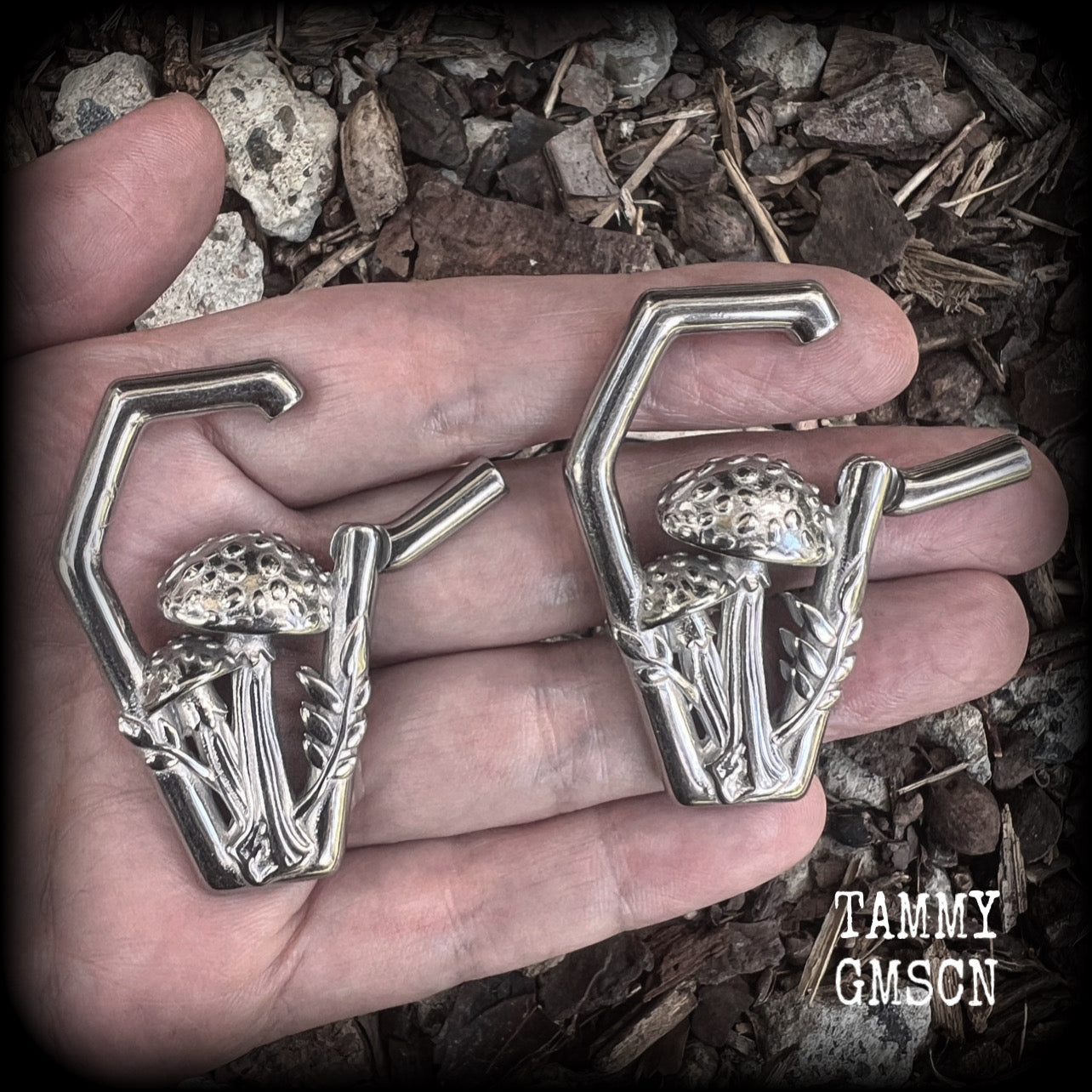 Featuring gorgeous surgical steel mushrooms enclosed in a coffin shaped frame, these earrings measure 5cms from tip to tip, and weigh approx 29 grams each.