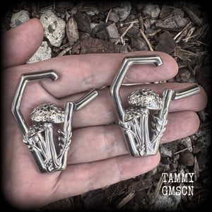 Featuring gorgeous surgical steel mushrooms enclosed in a coffin shaped frame, these earrings measure 5cms from tip to tip, and weigh approx 29 grams each.