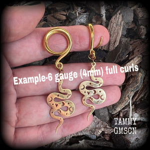 Inspired by the Voodoo Sky-father Damballah, these gorgeous earrings feature gold stainless steel celestial serpents, super lightweight at only a few grams a piece, and mesure just on 6.5cms from tip to tip.
These earrings have been made on 6 gauge (4mm) surgical steel full curl hooks, suitable for stretched lobes.