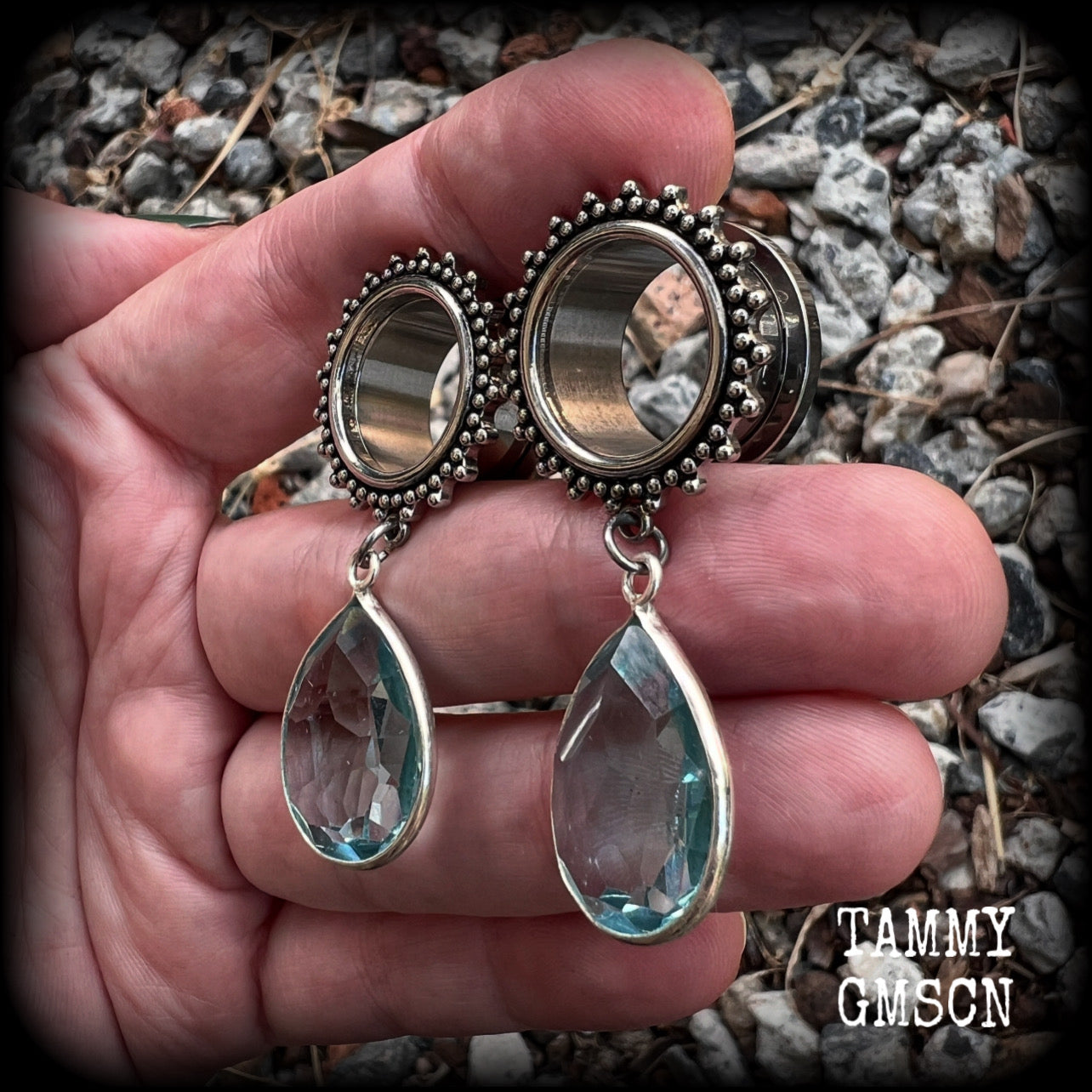 These gorgeous tunnel dangles feature beautiful blue topaz gemstones set in antique silver, weighing approx 16 grams each and measuring just over 5cms from tip to tip.
This pair has been made with 5/8 gauge (16mm) surgical steel ornate tunnels.