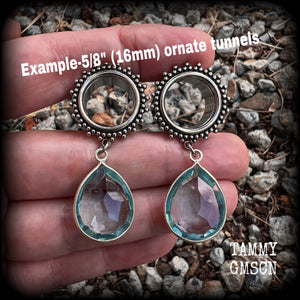 These gorgeous tunnel dangles feature beautiful blue topaz gemstones set in antique silver, weighing approx 16 grams each and measuring just over 5cms from tip to tip.
This pair has been made with 5/8 gauge (16mm) surgical steel ornate tunnels.