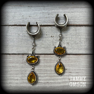 These earrings feature beautiful dangly yellow citrine gemstones in a gorgeous boho antique silver setting, lovely and dangly at just on 8.5cms from tip to tip, and weighing approx 11 grams each.
These earrings have been made on 5/8” gauge (16mm) surgical steel cradles, to be worn in stretched lobes.

