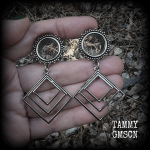 These gorgeous geometric tunnels feature 3 nestled antique silver diamonds, are lovely and dangly measuring just over 6 cms from tip to tip, and nice and light weight, weighing approx 9 grams each.
This pair has been made with 5/8" gauge (16mm) ornate surgical steel tunnels, suitable for stretched lobes.
