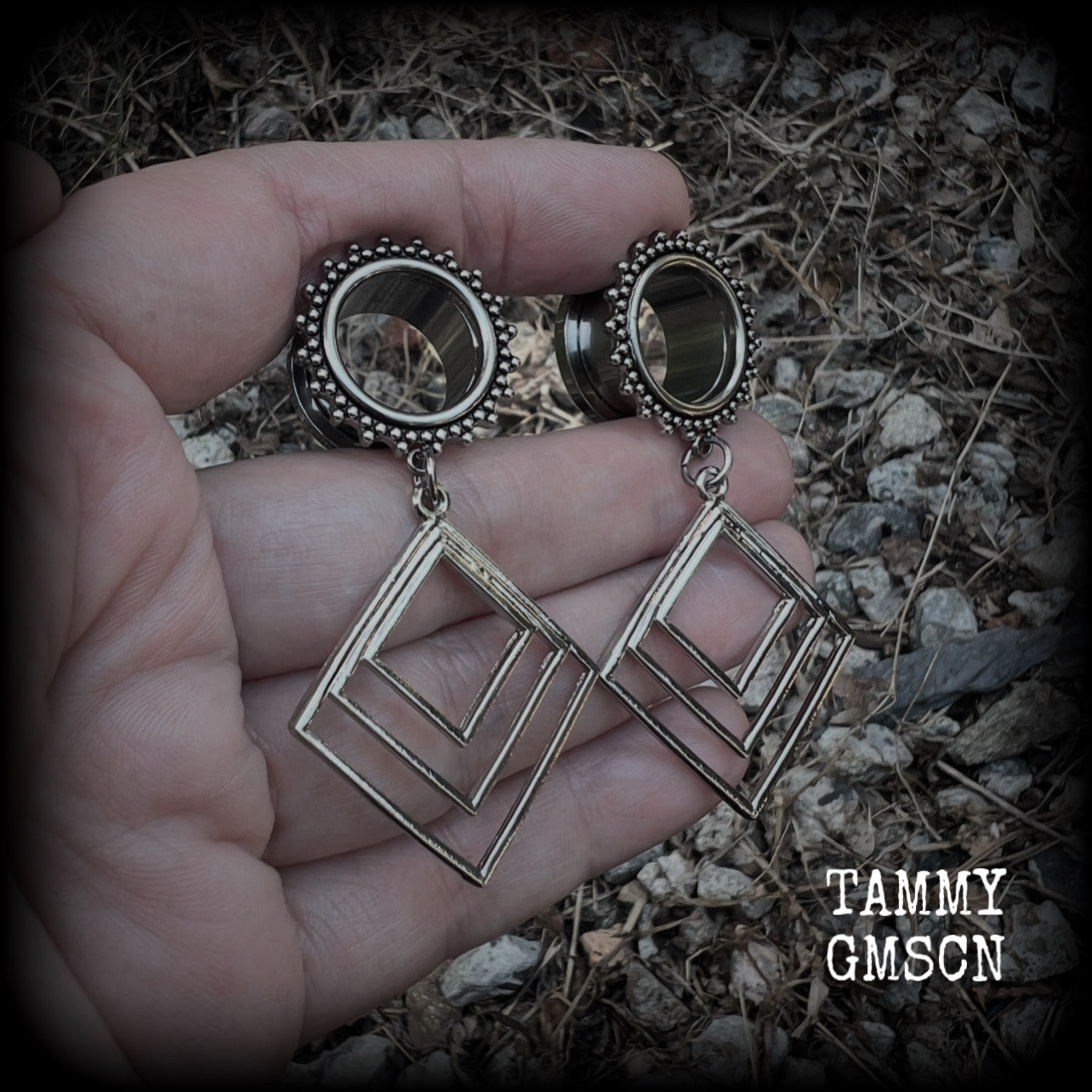 These gorgeous geometric tunnels feature 3 nestled antique silver diamonds, are lovely and dangly measuring just over 6 cms from tip to tip, and nice and light weight, weighing approx 9 grams each.
This pair has been made with 5/8" gauge (16mm) ornate surgical steel tunnels, suitable for stretched lobes.