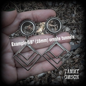 These gorgeous geometric tunnels feature 3 nestled antique silver diamonds, are lovely and dangly measuring just over 6 cms from tip to tip, and nice and light weight, weighing approx 9 grams each.
This pair has been made with 5/8" gauge (16mm) ornate surgical steel tunnels, suitable for stretched lobes.