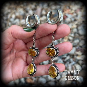 These earrings feature beautiful dangly yellow citrine gemstones in a gorgeous boho antique silver setting, 8.5cms from tip to tip, and weighing 11 grams each.
These earrings have been made on 5/8” gauge (16mm) surgical steel cradles.