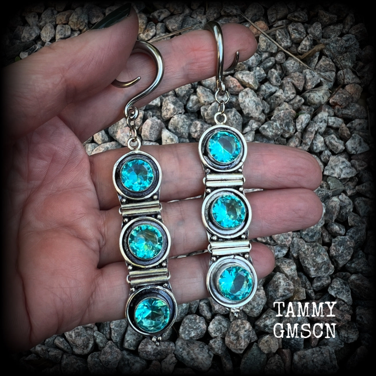 These earrings have been made with gorgeous facet ocean blue topaz gemstones in a beautifully boho antique silver setting, lovely and dangly at approx 9.5cms from tip to tip, and not too heavy at only 11 grams each.

These earrings have been made on 6 gauge (4mm) surgical steel full curl hooks, to be worn in stretched lobes.