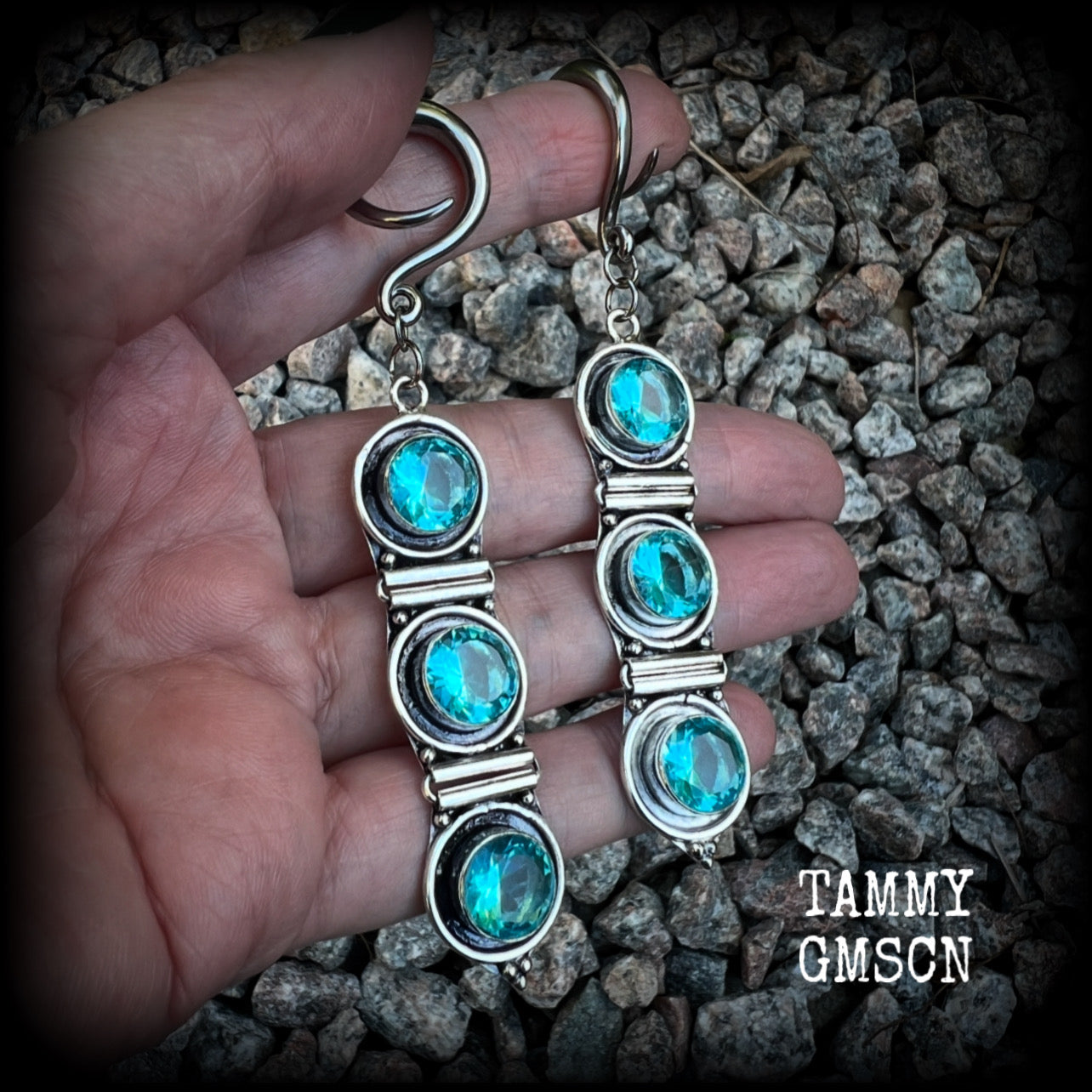 These earrings have been made with gorgeous facet ocean blue topaz gemstones in a beautifully boho antique silver setting, lovely and dangly at approx 9.5cms from tip to tip, and not too heavy at only 11 grams each.

These earrings have been made on 6 gauge (4mm) surgical steel full curl hooks, to be worn in stretched lobes.
