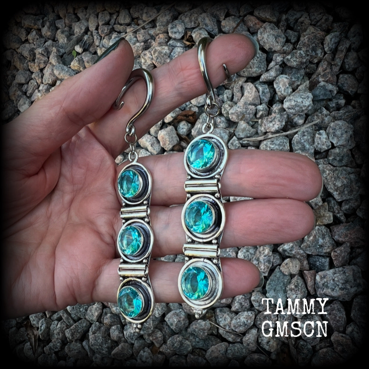 These earrings have been made with gorgeous facet ocean blue topaz gemstones in a beautifully boho antique silver setting, lovely and dangly at approx 9.5cms from tip to tip, and not too heavy at only 11 grams each.

These earrings have been made on 6 gauge (4mm) surgical steel full curl hooks, to be worn in stretched lobes.