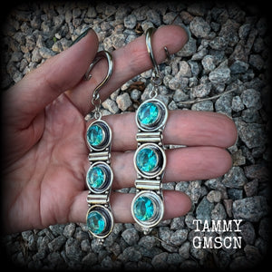 These earrings have been made with gorgeous facet ocean blue topaz gemstones in a beautifully boho antique silver setting, lovely and dangly at approx 9.5cms from tip to tip, and not too heavy at only 11 grams each.

These earrings have been made on 6 gauge (4mm) surgical steel full curl hooks, to be worn in stretched lobes.