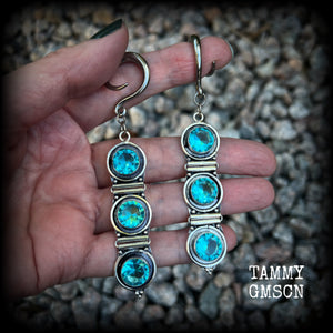 These earrings have been made with gorgeous facet ocean blue topaz gemstones in a beautifully boho antique silver setting, lovely and dangly at approx 9.5cms from tip to tip, and not too heavy at only 11 grams each.

These earrings have been made on 6 gauge (4mm) surgical steel full curl hooks, to be worn in stretched lobes.
