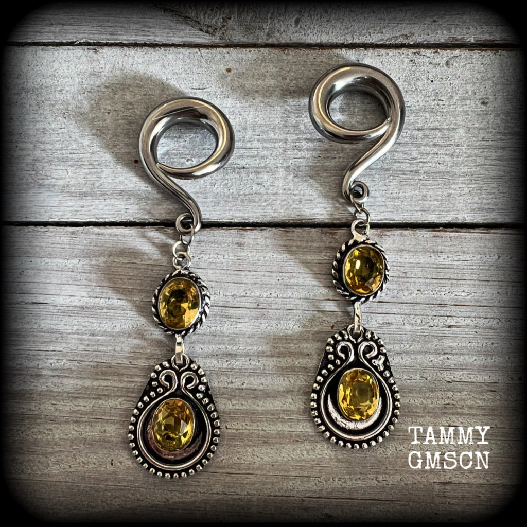 These beautiful boho gauged earrings have been made with gorgeous yellow citrine gemstones, lovely and dangly at just over 8cms from tip to tip, and weighing approx 14 grams each.

These earrings have been made on 2 gauge (6mm) surgical steel full curl hooks, to be worn in stretched lobes.