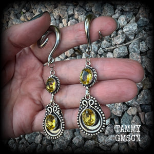 These beautiful boho gauged earrings have been made with gorgeous yellow citrine gemstones, lovely and dangly at just over 8cms from tip to tip, and weighing approx 14 grams each.

These earrings have been made on 2 gauge (6mm) surgical steel full curl hooks, to be worn in stretched lobes.