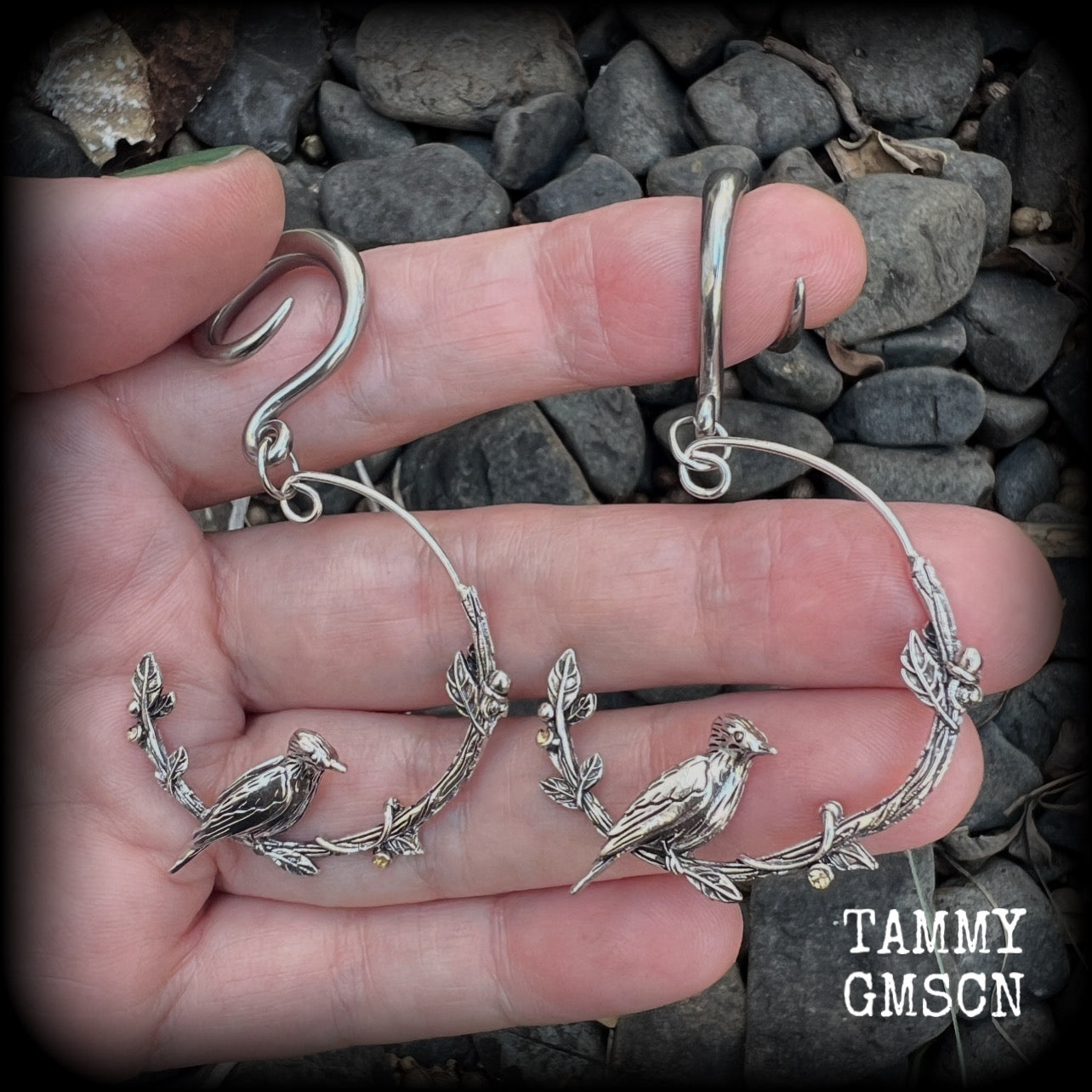Featuring a gorgeous antique silver bird sitting on a branch wrapped with beautiful leafy vines, these delicate earrings measure just on 6.5 cms from tip to tip, and weigh approx 8 grams.
This pair have been made on 6 gauge (4mm) stainless steel full curl hooks, suitable for stretched lobes.