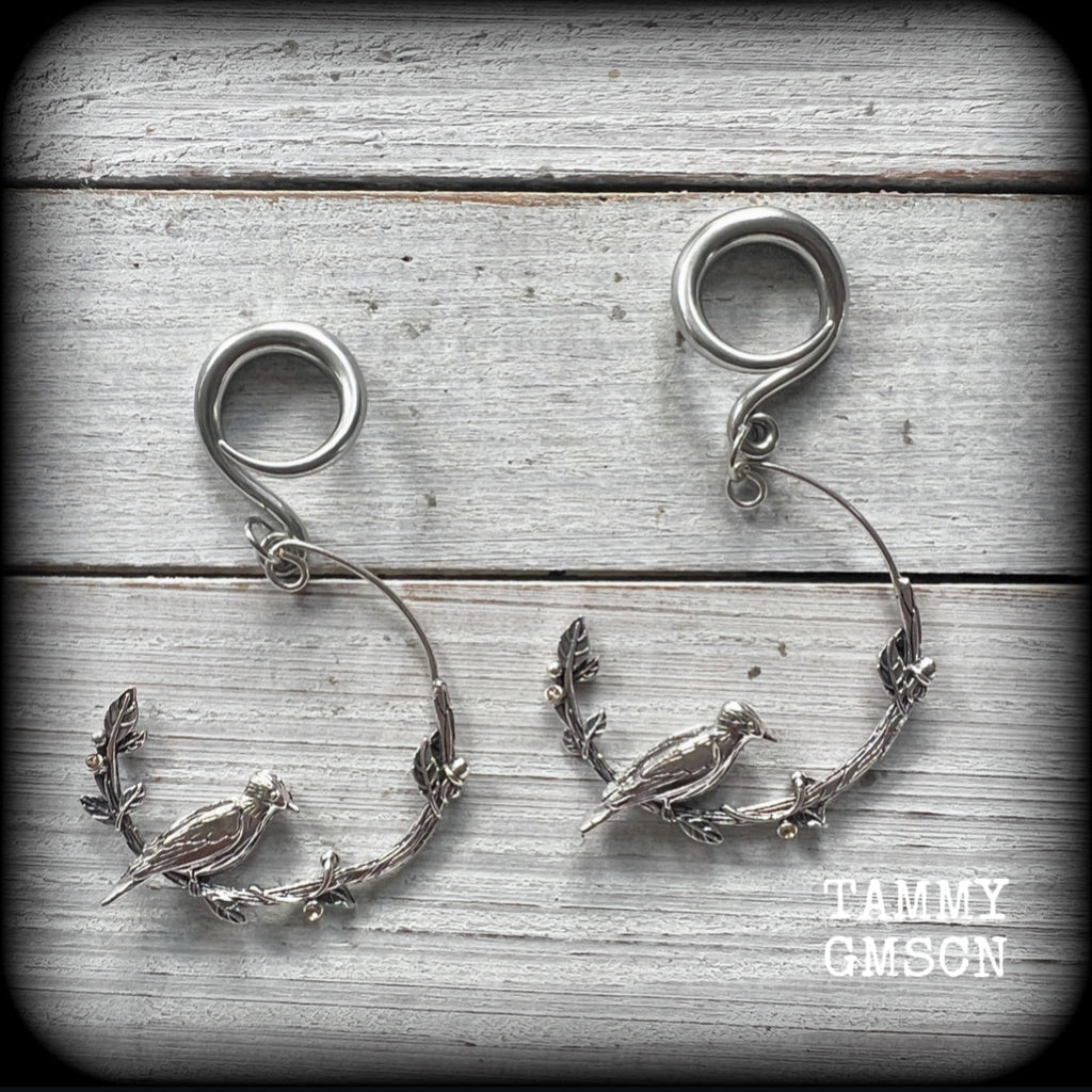 Featuring a gorgeous antique silver bird sitting on a branch wrapped with beautiful leafy vines, these delicate earrings measure  6.5 cms from tip to tip, and weigh 8 grams.
This pair have been made on 6 gauge (4mm) surgical steel full curl hooks.