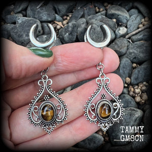 These earrings feature beautiful tigers eye gemstones in a gorgeous boho antique silver setting, lovely and petite at 6cms from tip to tip, and weighing approx 6 grams each.
These earrings have been made on 1/2” gauge (12mm) surgical steel cradles