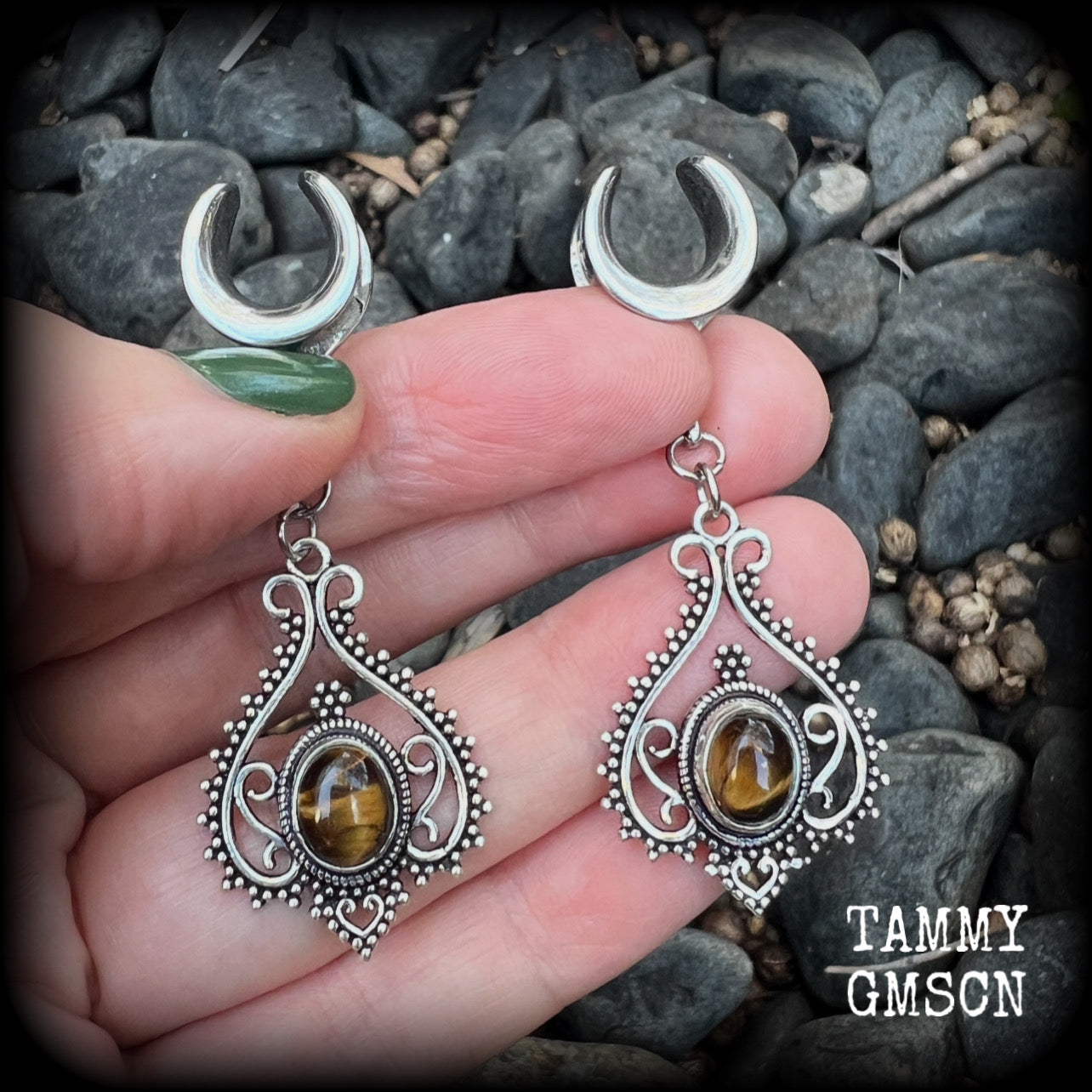 These earrings feature beautiful tigers eye gemstones in a gorgeous boho antique silver setting, lovely and petite at 6cms from tip to tip, and weighing approx 6 grams each.
These earrings have been made on 1/2” gauge (12mm) surgical steel cradles