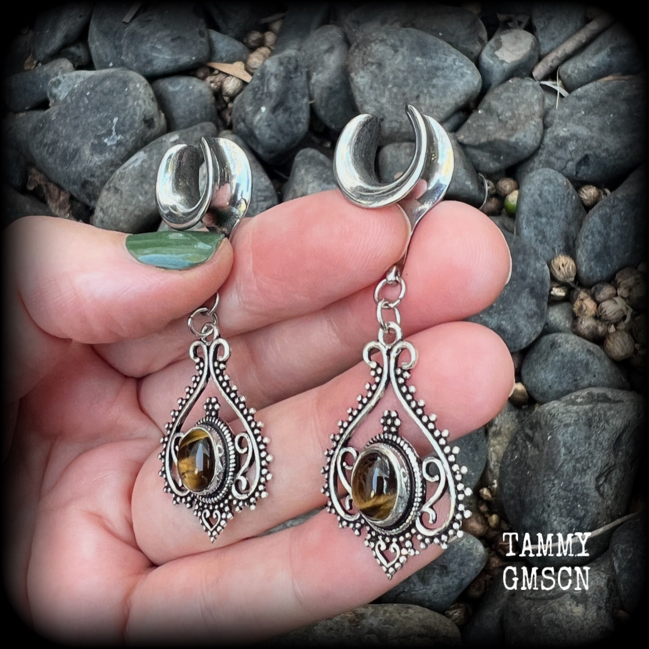 These earrings feature beautiful tigers eye gemstones in a gorgeous boho antique silver setting, lovely and petite at 6cms from tip to tip, and weighing approx 6 grams each.
These earrings have been made on 1/2” gauge (12mm) surgical steel cradles