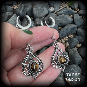 These earrings feature beautiful tigers eye gemstones in a gorgeous boho antique silver setting, lovely and petite at 6cms from tip to tip, and weighing approx 6 grams each.
These earrings have been made on 1/2” gauge (12mm) surgical steel cradles