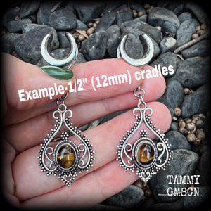 These earrings feature beautiful tigers eye gemstones in a gorgeous boho antique silver setting, lovely and petite at 6cms from tip to tip, and weighing approx 6 grams each.
These earrings have been made on 1/2” gauge (12mm) surgical steel cradles