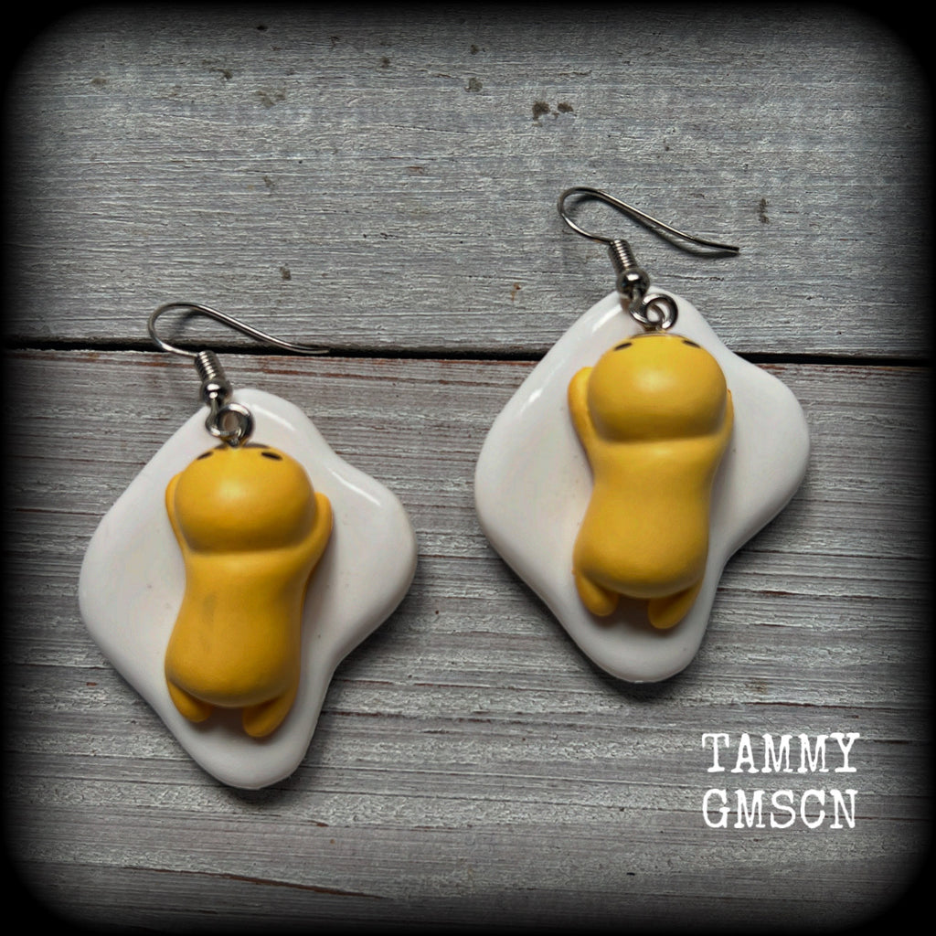 These earrings are TOO CUTE!!! Featuring the adorable Gudetama lazy egg man himself laying on a bed of egg whites, these earrings measure just on 6cms and weigh approx 8 grams.
This pair has been made on stainless steel french hooks, suitable for pierced ears.
