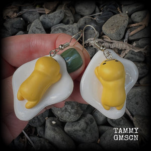 These earrings are TOO CUTE!!! Featuring the adorable Gudetama lazy egg man himself laying on a bed of egg whites, these earrings measure just on 6cms and weigh approx 8 grams.
This pair has been made on stainless steel french hooks, suitable for pierced ears.